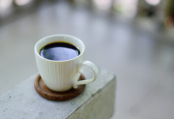 Fototapeta na wymiar Hot coffee cup on railing, Coffee at home