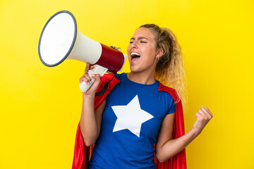 Super Hero woman isolated on yellow background shouting through a megaphone to announce something in lateral position © luismolinero