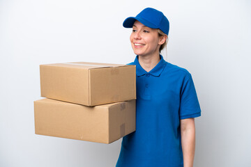 Delivery caucasian woman isolated on white background looking to the side and smiling