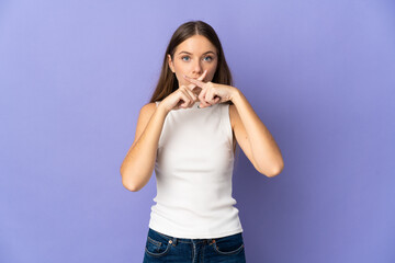 Young Lithuanian woman isolated on purple background showing a sign of silence gesture