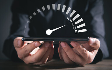 Male hand showing speedometer with a Value word.