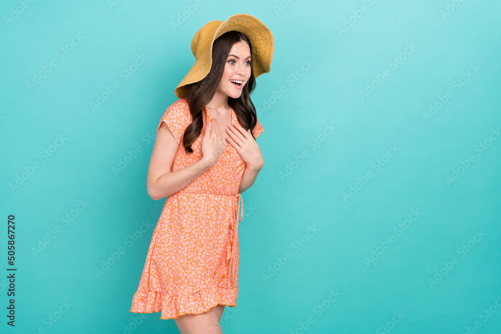 Wall mural Photo of pretty excited woman wear orange outfit panama arms chest looking empty space isolated turquoise color background