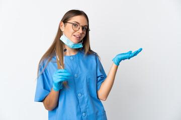Lithuanian woman dentist holding tools over isolated background extending hands to the side for...
