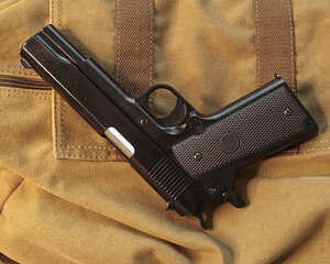 Hand Gun . Isolated. Flat Lay. Shotgun lying on messenger bag. Stock Image.