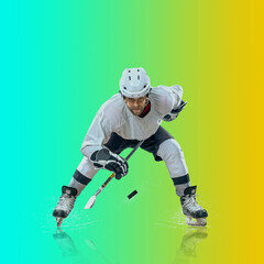 Fototapeta na wymiar Professional ice hockey player hitting puck for winning goal in action on gradient multicolored neon background. Concept of sport competition.