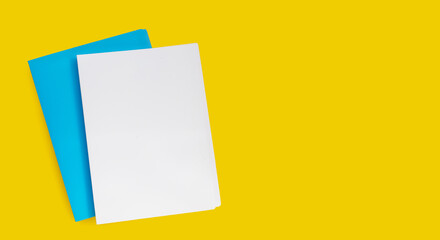 Office folders on yellow background. Top view