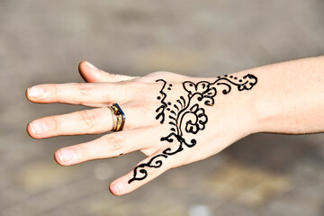 tatoo henna and hand with ring, photo as background