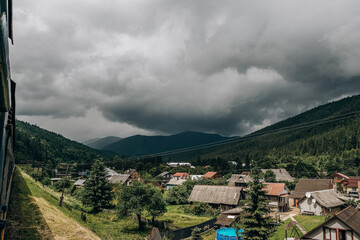 Fototapeta premium Travel to the mountains by train in summer. Beautiful scenery from the train window.