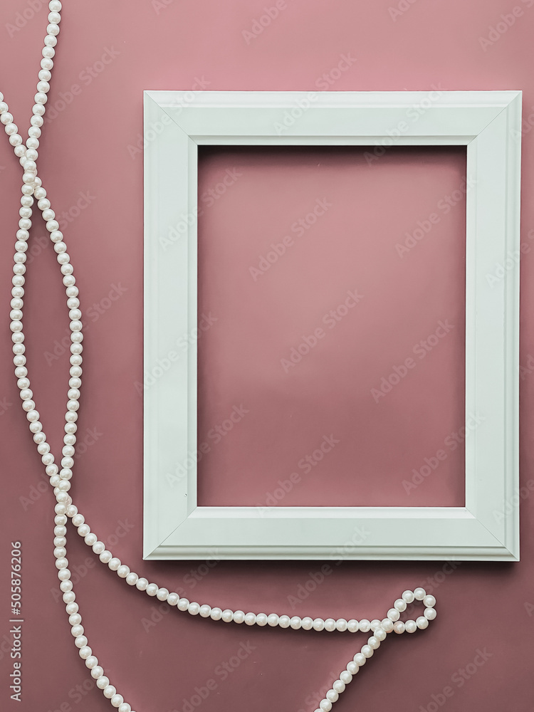 Wall mural vertical frame and pearl jewellery on blush pink background as flatlay design, artwork print or phot