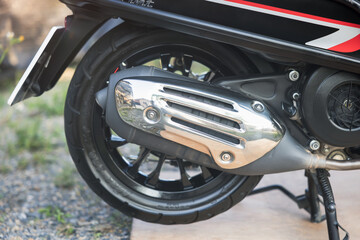 Exhaust or muffler on classic scooter. Auto part with tuning steel tube pipe or silencer and...
