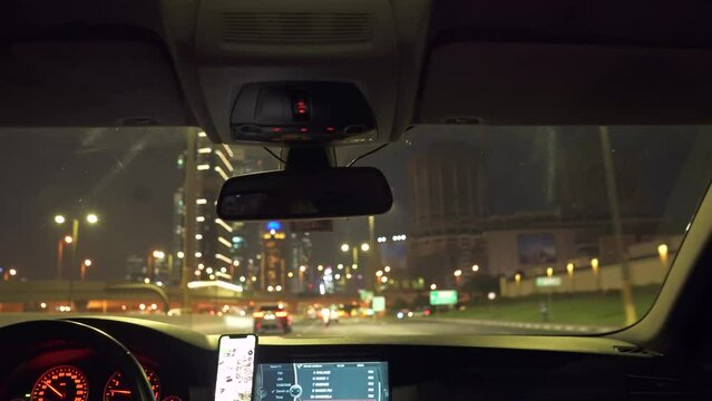Driving a car on Dubai Marina street at night. Inside car view driving in Dubai UAE at night