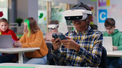 Teen girl student using vr headset and remote controllers in classroom