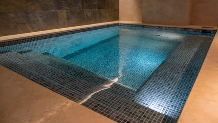 Indoor swimming pool in hotel spa center or sauna. Modern concrete house with indoor pool. Nobody...