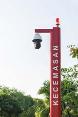 Emergency pole with CCTV is located in the public garden. (English translation for foreign language...