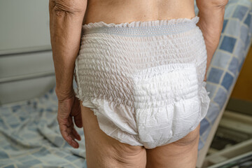 Asian senior or elderly old lady woman patient wearing incontinence diaper in nursing hospital...