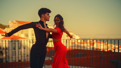 Beautiful Couple Dancing a Latin Dance Outside the City with Old Town in the Background. Sensual...