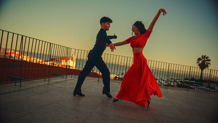 Beautiful Couple Dancing a Latin Dance Outside the City with Old Town in the Background. Sensual...