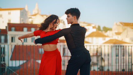 Beautiful Couple Dancing a Latin Dance Outside the City with Old Town in the Background. Sensual...