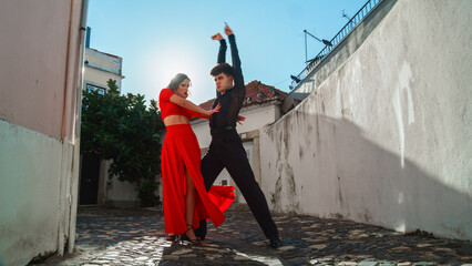 Beautiful Couple Dancing a Latin Dance on the Quiet Street of an Old Town in a City. Sensual Dance by Two Professional Dancers on a Sunny Day Outside in Ancient Culturally Rich Tourist Location.
