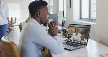 African american businessman using laptop for video call with african american business colleague - Powered by Adobe