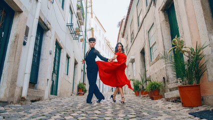Beautiful Couple Dancing a Latin Dance on the Quiet Street of an Old Town in a City. Sensual Dance by Two Professional Dancers on a Sunny Day Outside in Ancient Culturally Rich Tourist Location. - obrazy, fototapety, plakaty