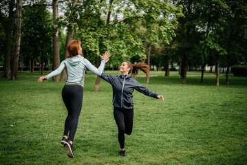 Two women sportswomen doing sports outdoors.