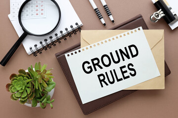 GROUND RULES. text on paper on an envelope and diary on the desk