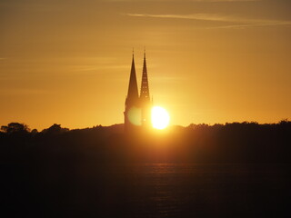 Fototapeta na wymiar Sunset behind the Douvres-la-Délivrande church in Normandy, France
