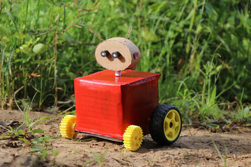 Four wheeled robot with a head and eyes which was a part of a science exhibition placed outdoors