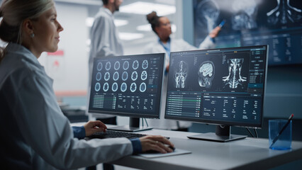 Medical Hospital Health Care Lab: Portrait of Female Medical Scientist Using Computer with Brain Scan MRI Images, Finding Cure. Professional Neurologist Analysing CT Scan Finding Cure for Sick Patient - obrazy, fototapety, plakaty