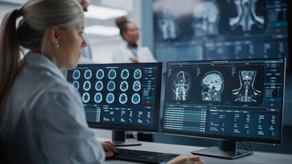 Medical Hospital Health Care Lab: Camera Captures Professional Neuroscientists Analysing CT Scan...