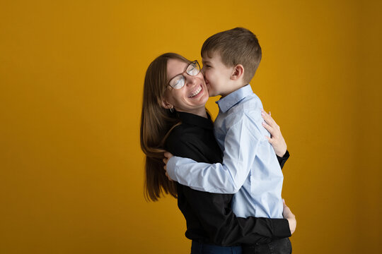 Loving mother hugging happy son