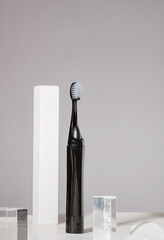Modern rechargeable toothbrush with copy space on grey background