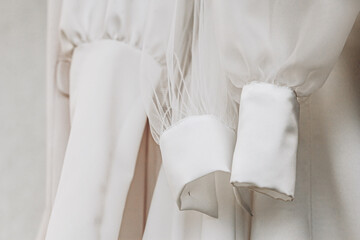 Sleeves of white wedding chiffon half-sewn dresses with needles