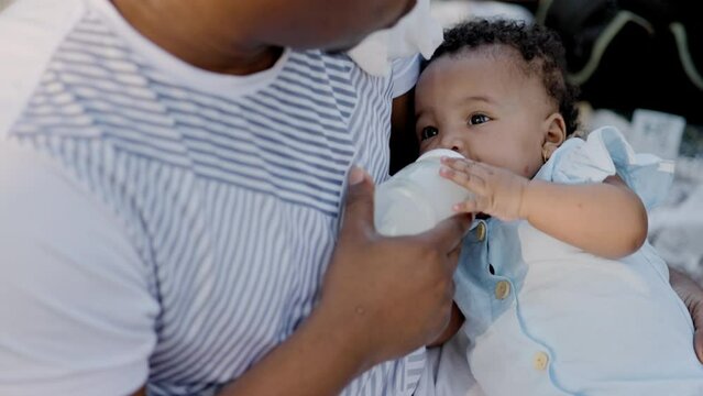 African American father Take care daughter with love in garden during summer. family Parent of newborn children take happy picnic. life together. love and care for toddlers. international father's day