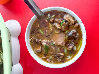 Coto Makassar or beef soup, traditional culinary from Makassar, South Sulawesi, Indonesia.