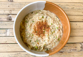 bowl of oatmeal porridge with egg.