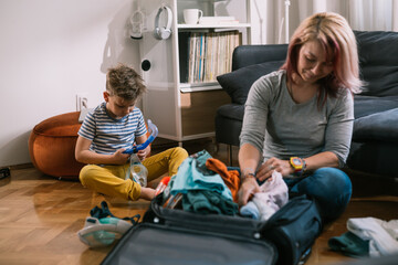 family packing bags for summer vacation