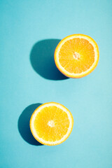 Two pieces of fresh orange on blue background.
