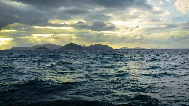 Flying above Indian Ocean towards the Praslin Island in Seychelles at sunset