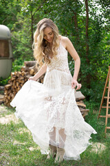 Fototapeta premium A bride on a ranch in a white dress and boots