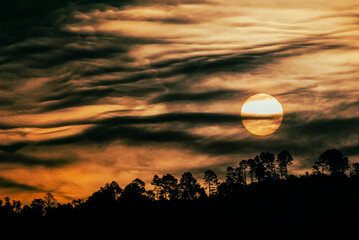 Fototapeta premium Sunrise in rural Guatemala, dramatic sky with intense play of clouds, open air in Central America.