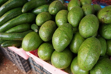 Avocados are in the basket for sale.