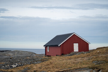 Fototapeta na wymiar solitaire seafron traditional red house in norway located in Bud, Norway 