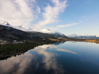 Fototapeta na wymiar reflections of snowy mountains in the lake in Norway - beautiful landscape with lake and mountains