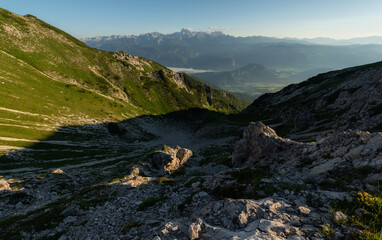 Sunrise mountains silhouette in the Julian Alps. Beautiful morning at the summit of the hills. 