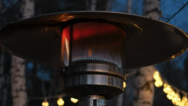 Close up. Gas heater on the ocean. Night time.