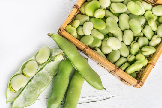 top view ripe broad beans on white wooden background