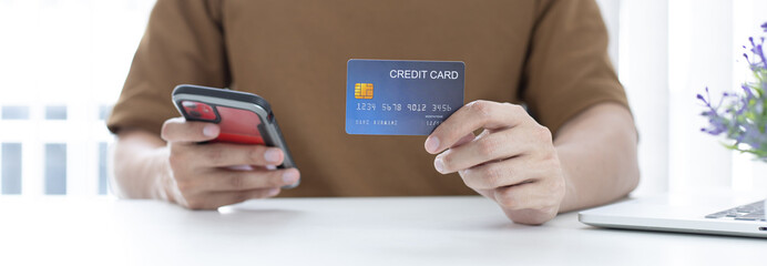 Men use smart phone to register online purchases using credit card payments, Convenience in the world of technology and the internet, Shopping online and banking online concept.