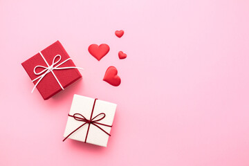 Valentine's Day. Gifts in the form of hearts on a pink background with the inscription love. Copy...